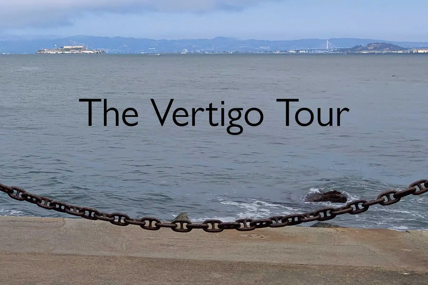 The Vertigo Tour cover featuring the San Francisco Bay viewed from the pier with chain in the foreground.